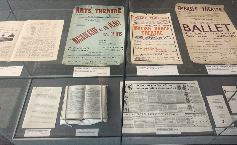 2 shelves displaying items from the Warren Lamb archive. The top shelf features mainly posters for performances of British Dance Theatre. The bottom shelf shows publicity material relating to Lamb's consultancy work.