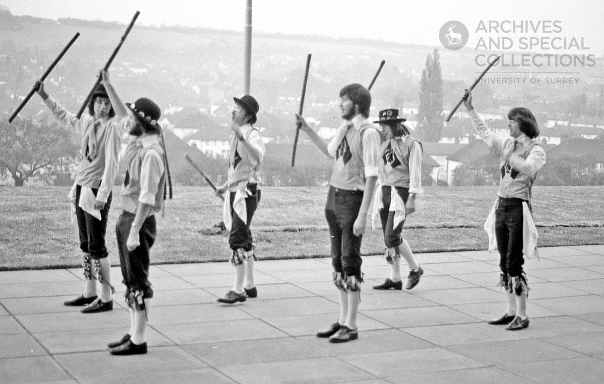 Photograph of Morris dancers with sticks outside of Guildford Cathedral