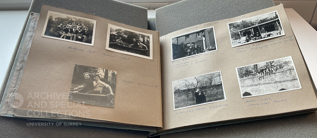 A photograph album with its pages open. A selection of small black and white photographs of students are visible.