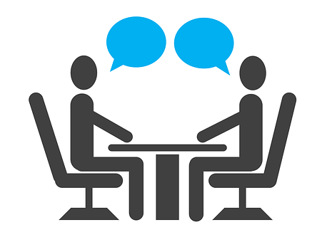 A cartoon image of people talking to each other over a table, in an interview situation, each person has a speech bubble