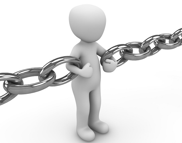 Figure holding onto links in a chunky metal chain