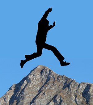 Infographic silhouette of figure leaping over the top of a mountain