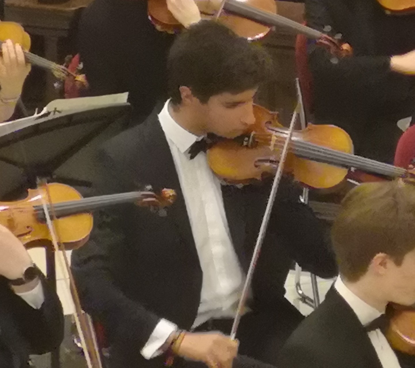 Ignacio playing the violin in a concert