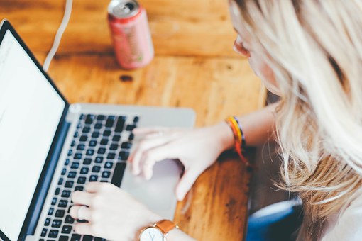 Woman typing at a laptop