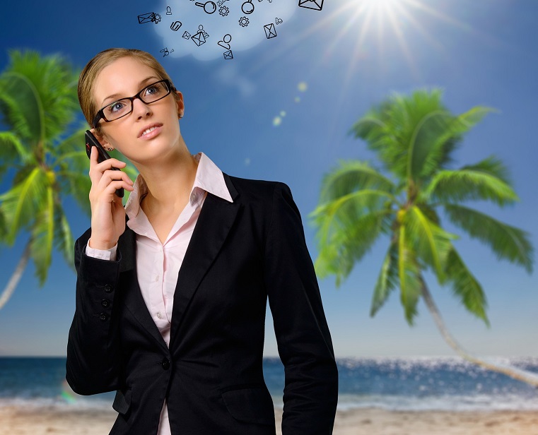 Summer intern on phone on beach with palm trees