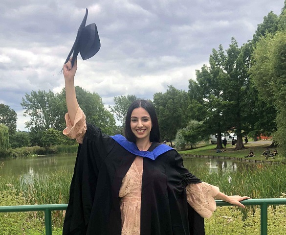 Chryso celebrating graduating from university of surrey, by the lake