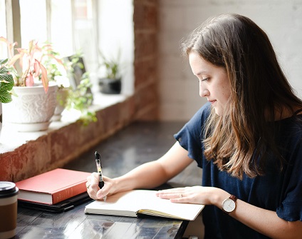 Student or graduate writing down her summer plans