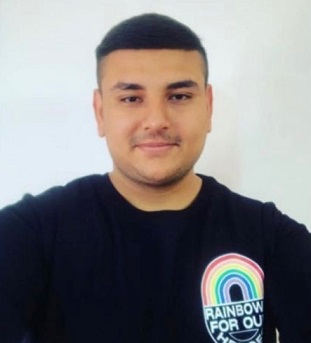 Image of Jai wearing a t-shirt featuring a rainbow with log 'Rainbow for our heroes'