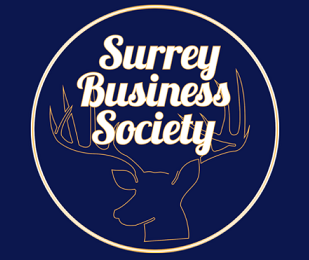 The logo from the Surrey Business Society. Featuring a stage in a circle and the words Surrey Business Society over the top.