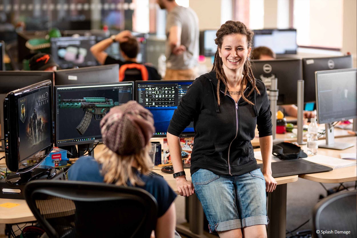 2 female games designers chatting in their office setting