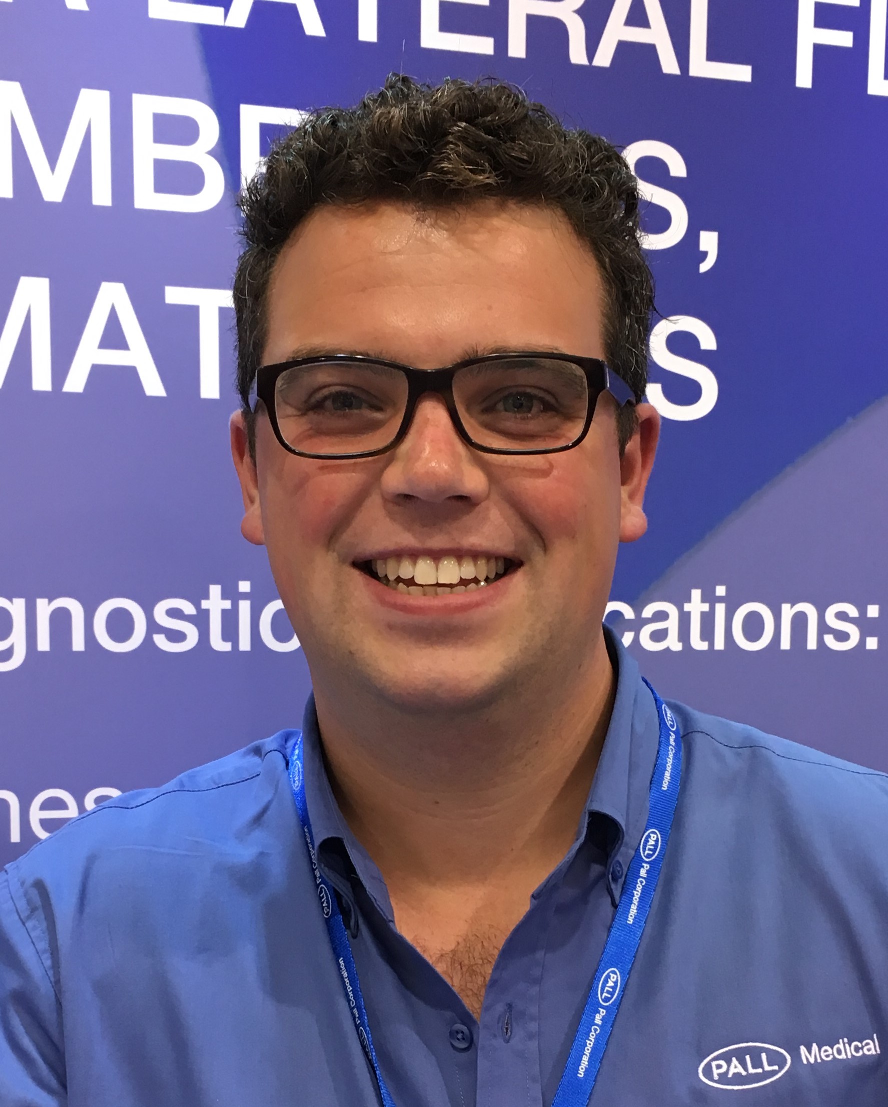 Surrey chemical engineering graduate Joseph, smiling and wearing his Pall lanyard