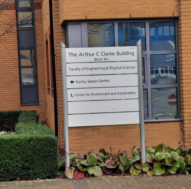 A sign indicating the name of a building and the various labs in that building. 