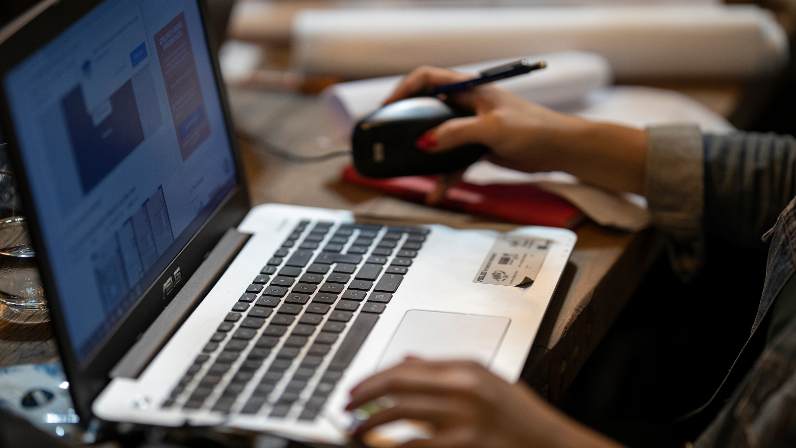 Image of a person sitting at a laptop and looking at the screen, studying. 