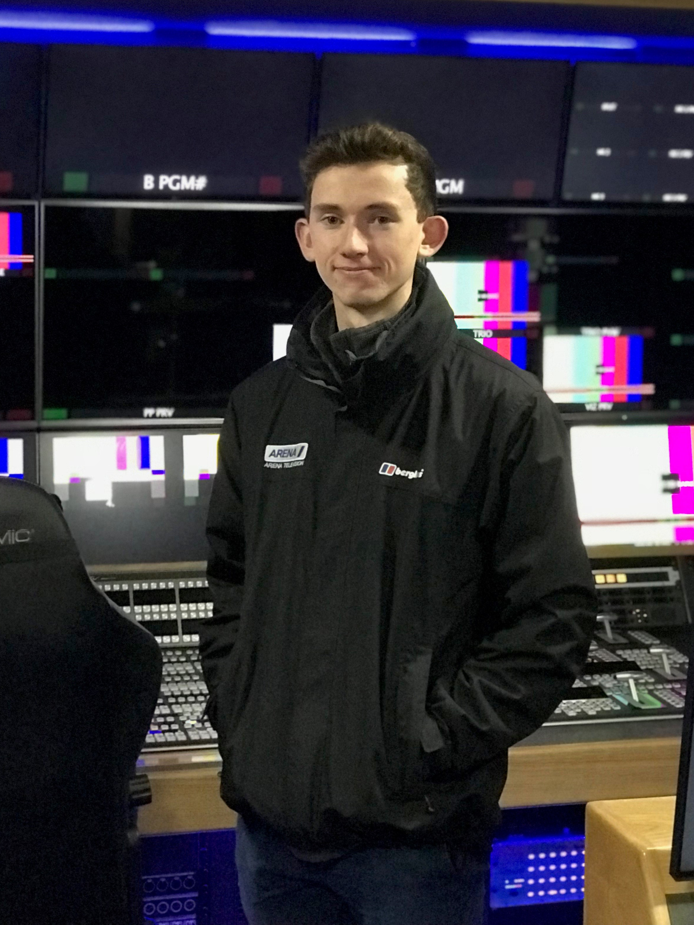 Student in front of TV production gallery