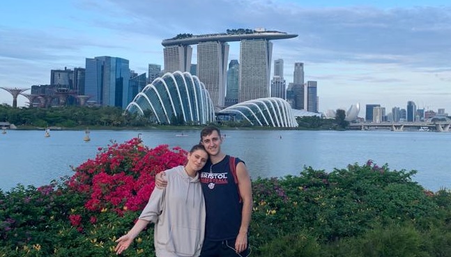 Two students with the Singaporean skyline in the background