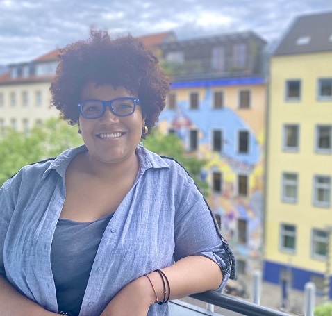 A picture of me on the balcony of a friend's home overlooking a street in Kreutzberg, Berlin.