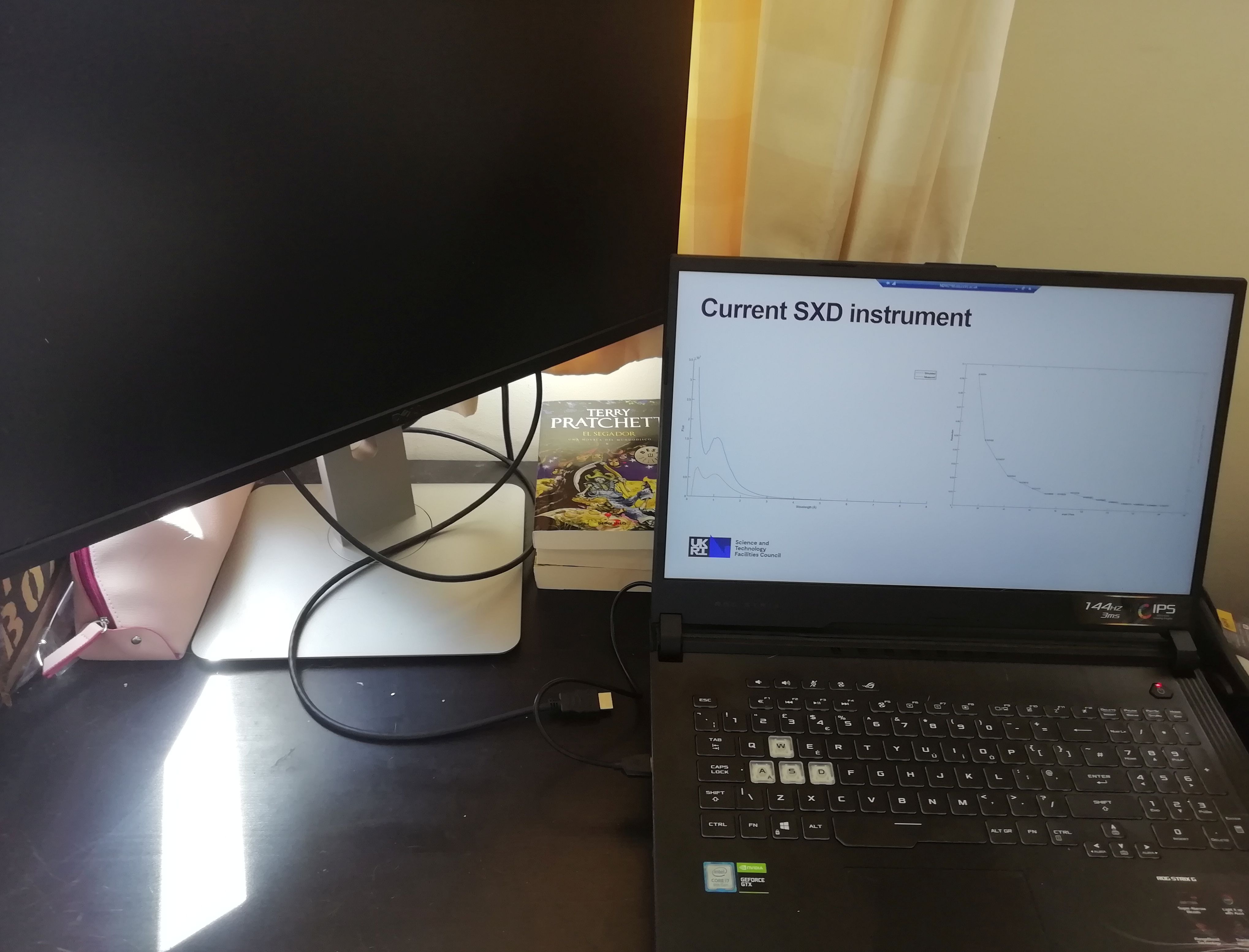 An image of a laptop and screen being used for remote working