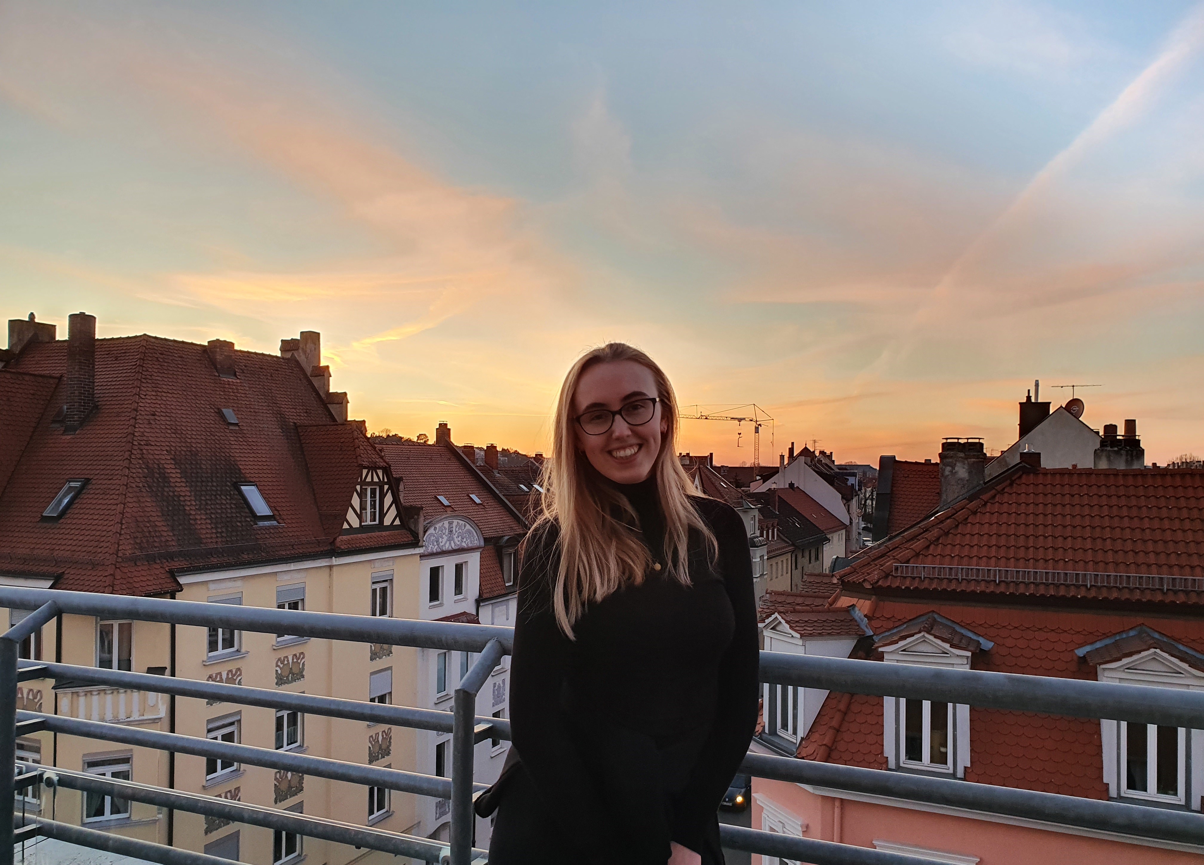 Image of me with a sunset background from a student accommodation terrace