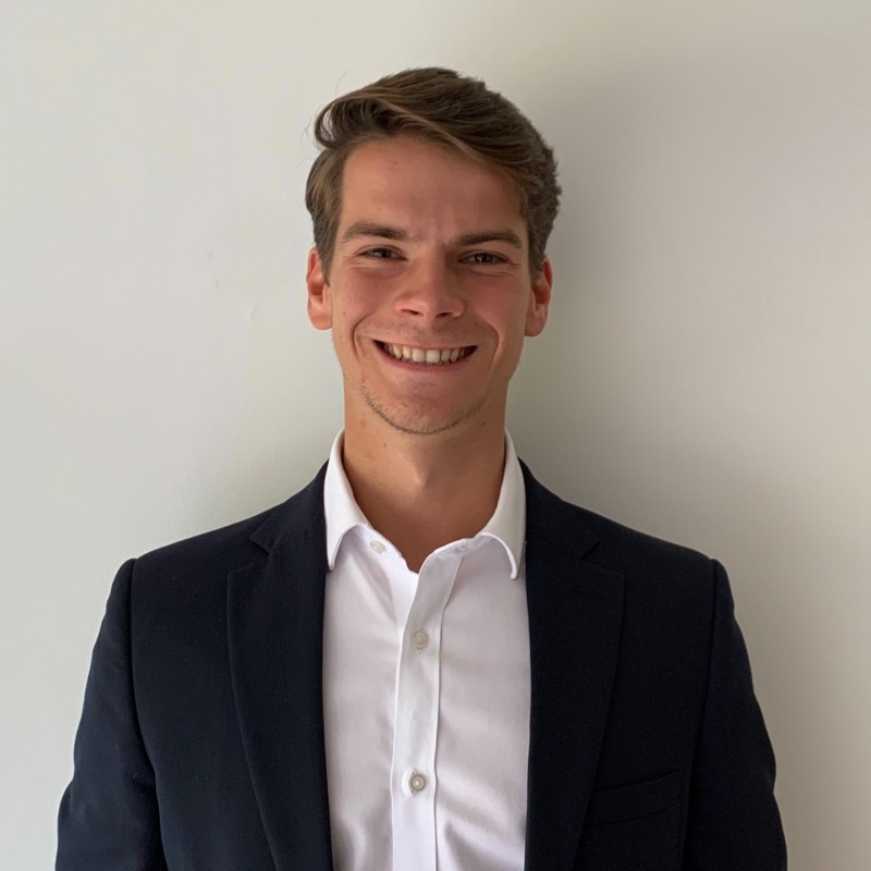 portrait shot of Nick, who is a Surrey student on placement at Atos.

Nick is dressed smartly in shirt and suit jacket and is smiling