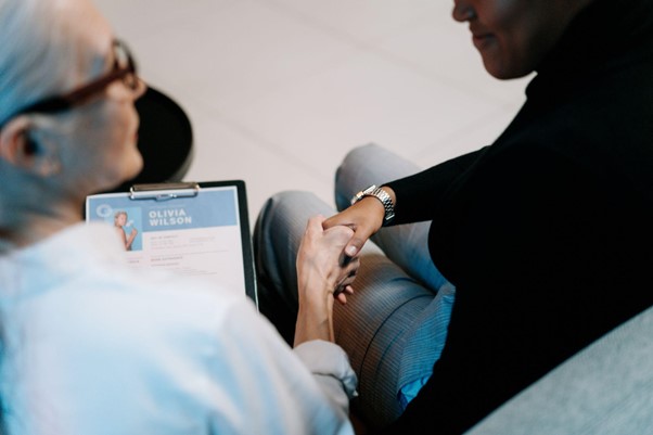 Two people shaking hands before a job interview.