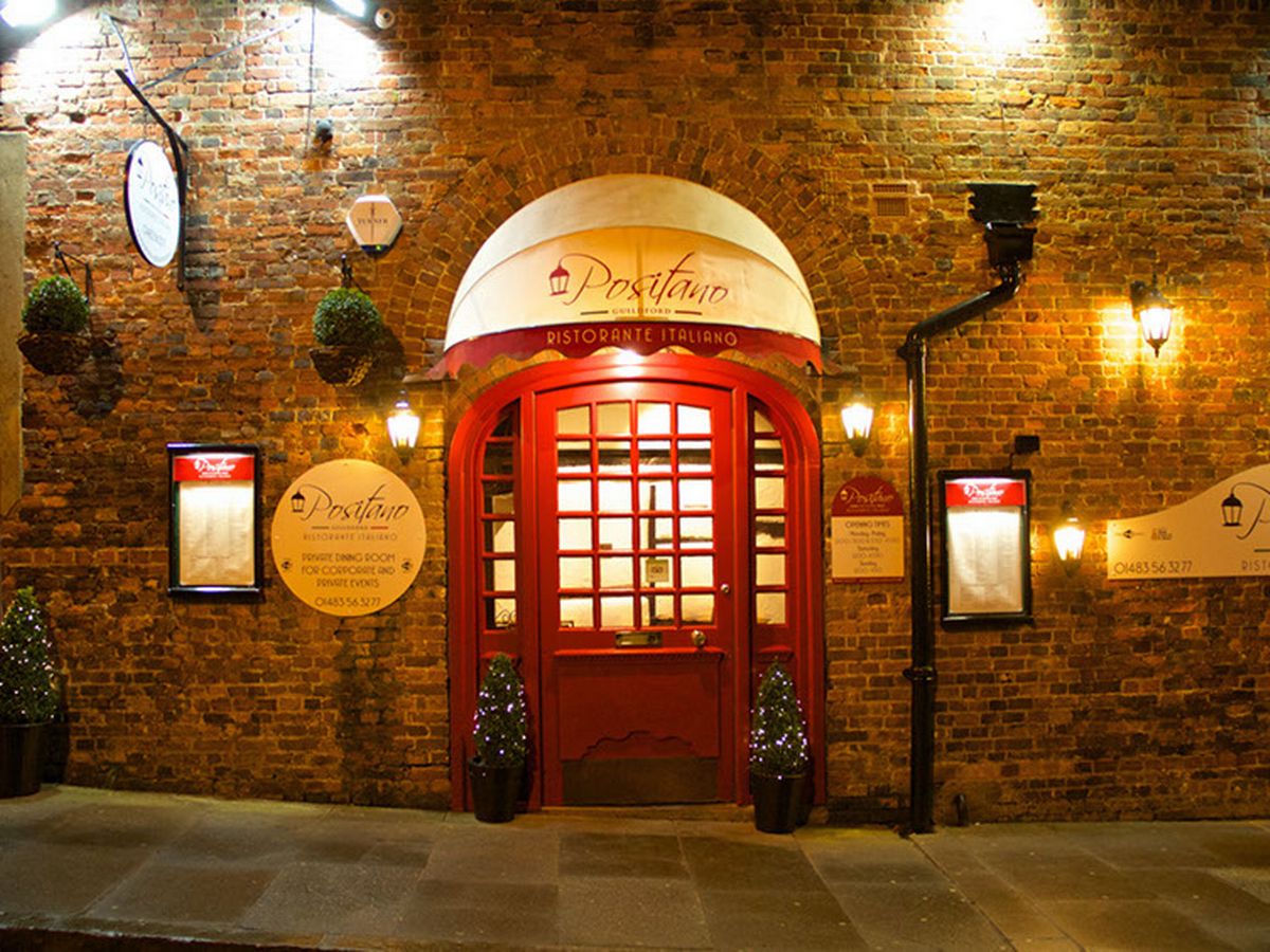Positano's restaurant entrance in Guildford. Very nice classic looking building, soft lighting and red door entrance. 