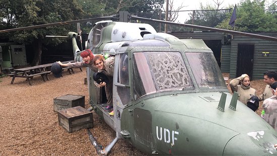 Delta Force Paintball couse, people smiling whilst in the interactive course including a helicopter hideout