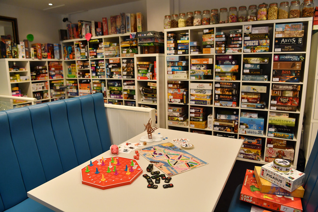 Unplug + Play, Board game cafe in Guildford, Surrey. photographer byline Darren Pepe.
Board games in background and on table