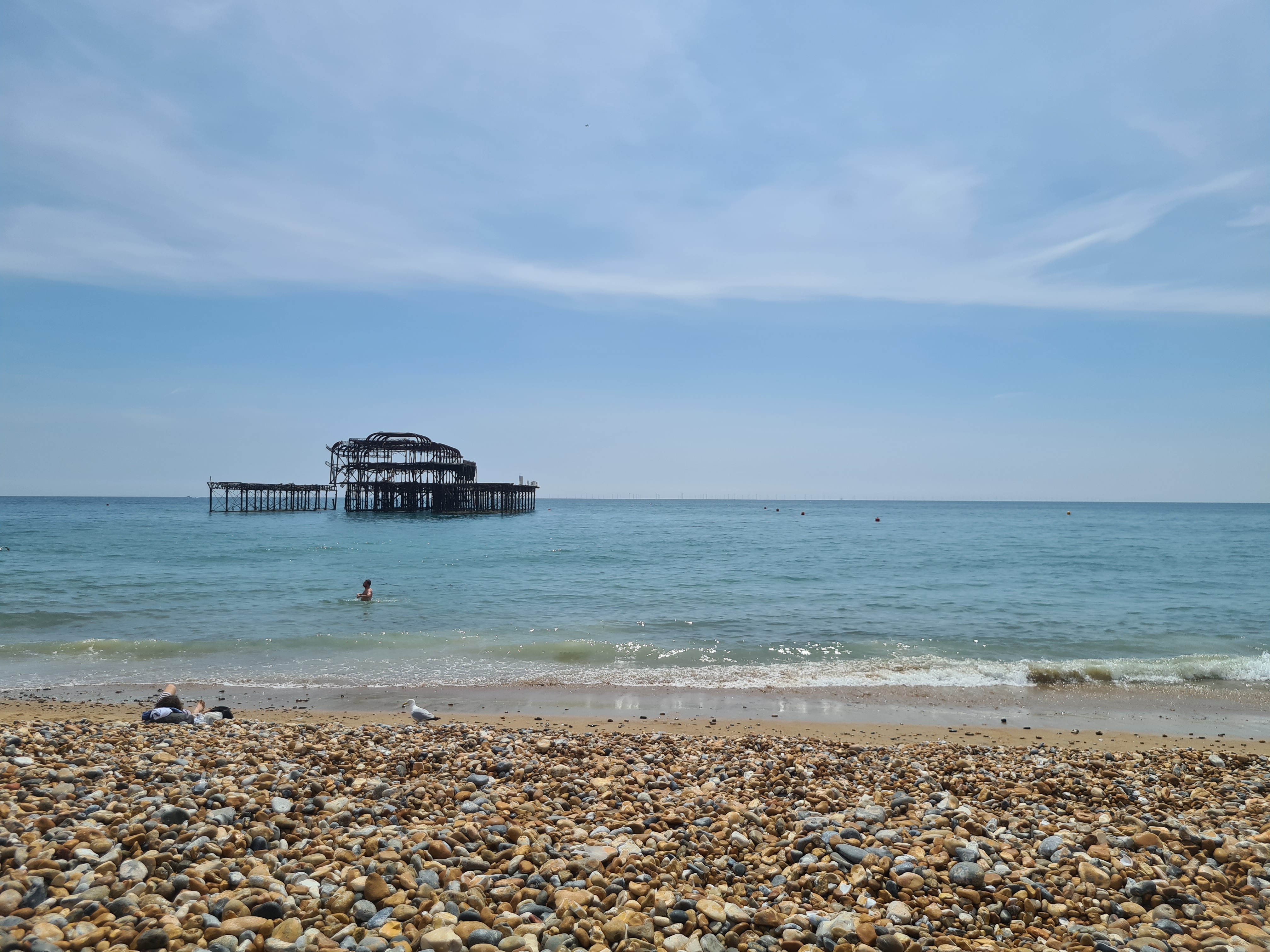 A photograph of Brighton Beach with the old pier in the distance