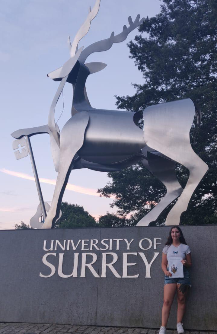 University of Surrey Student in front of Stag Hill Stag 