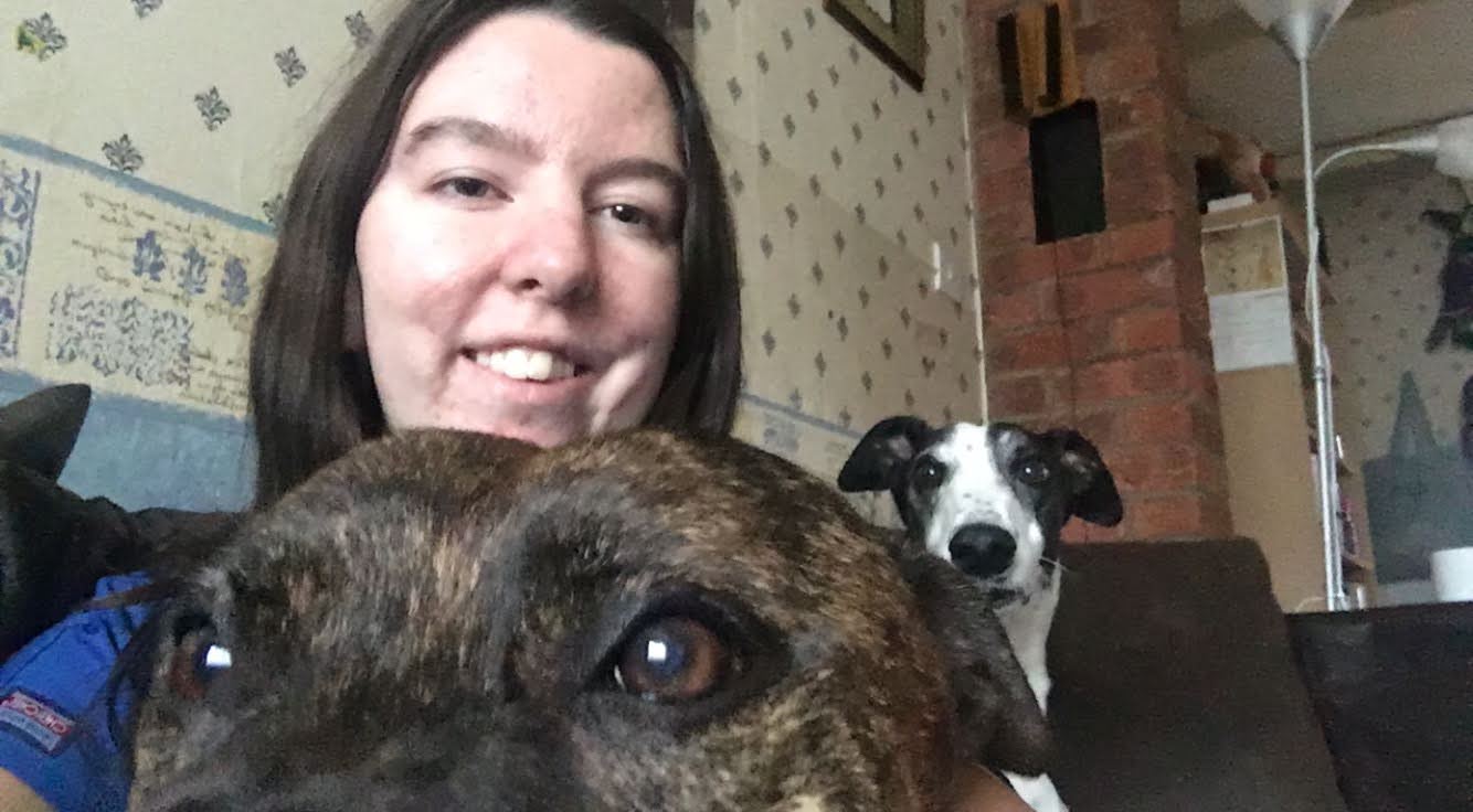 Surreystudent cuddles her dogs at home 