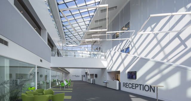 Inside of VSM (vet school main building) atrium with staircases, comfy chairs and hanging decorations