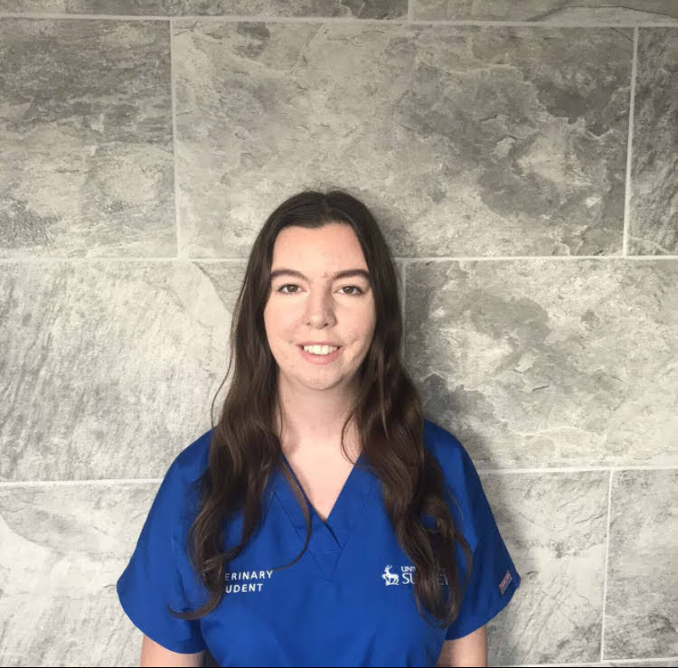 Uni of surrey vet student in blue uniform scrubs 