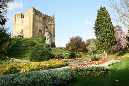 Guildford castle grounds with castle ruins and gardens with nicely brightly coloured flowers planted 
