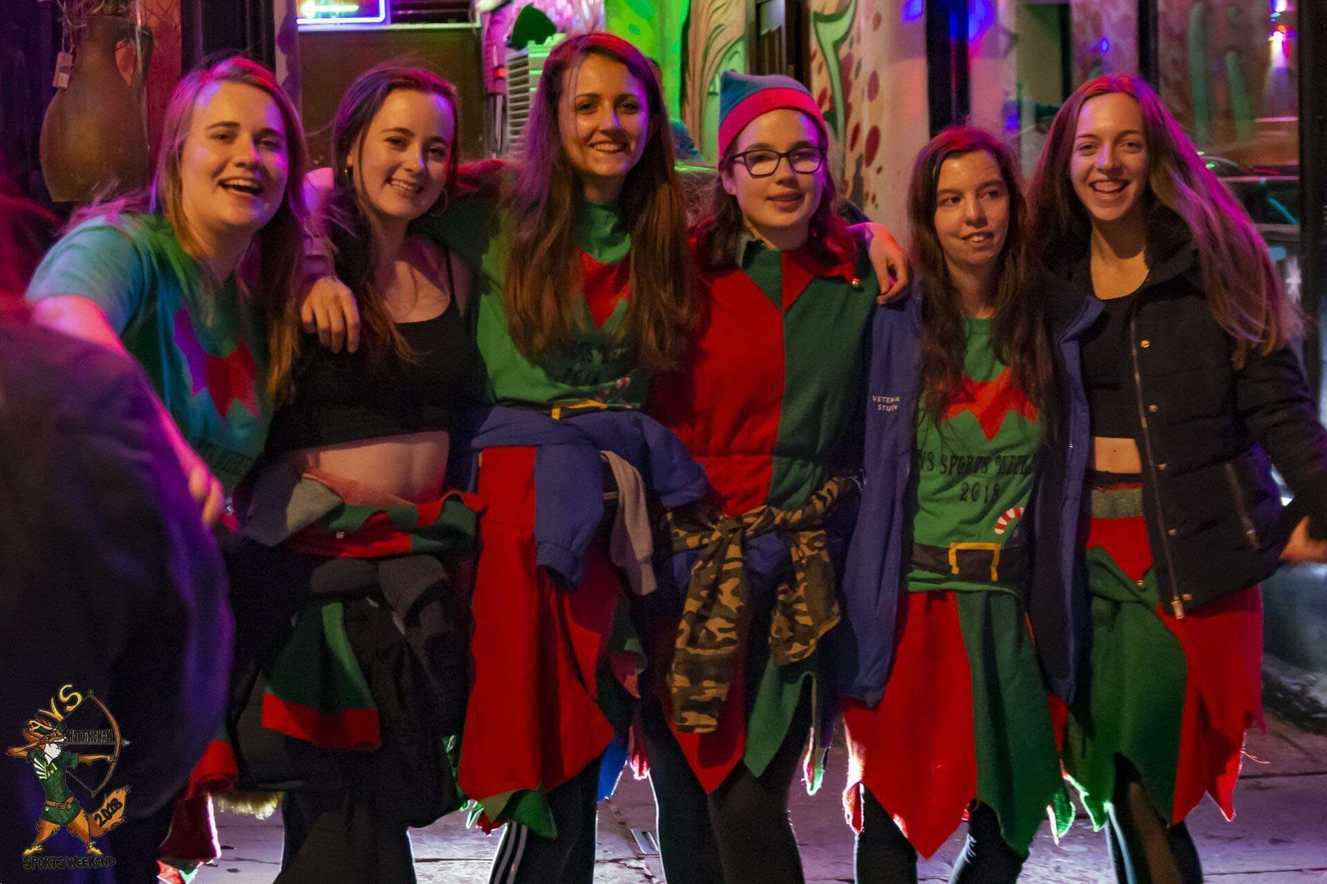 Friends in elf costumes pose for group photo on night out 