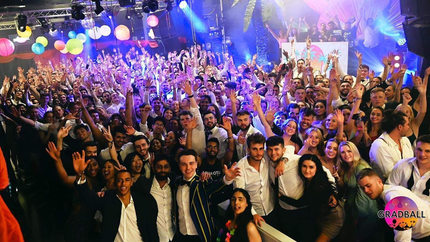 Gradball 2021 University of Surrey Students Union photo of students on dance floor in formal wear smiling and celebrating