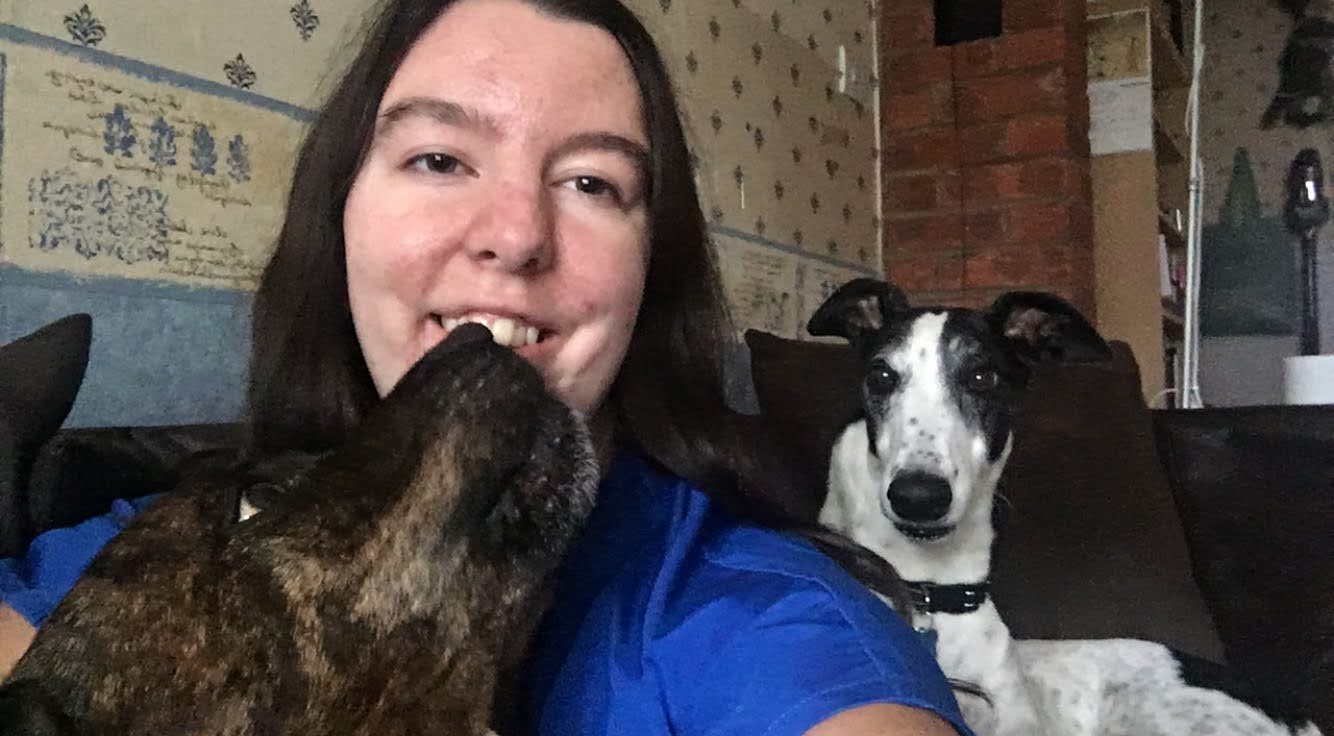 Vet Student cuddling with dogs 